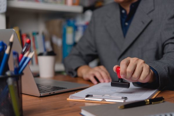 A professional applies an official seal to company document