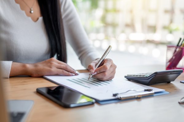 Business woman hand pointing to graph information.