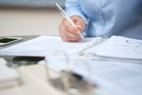 Businesswoman signing document