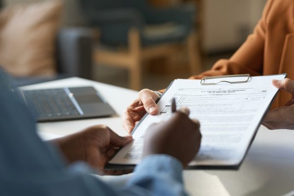 Closeup of Woman Signing Tax Declaration